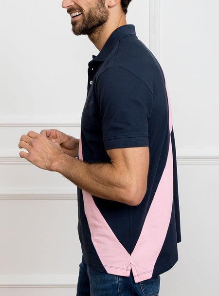Man wearing navy 100% cotton polo shirt with pale pink sash detail and Newmarket 875 horse logo embroidered on the front.